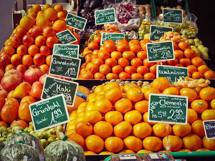 Colorful fruit stand display with handwritten price signs