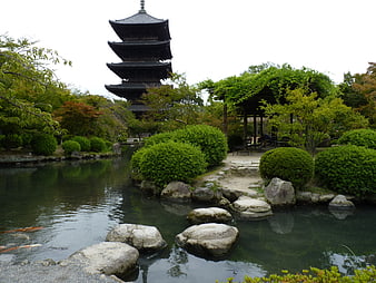 Traditional Japanese Garden With Pagoda, Pond, And Koi Fish