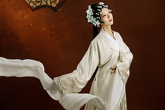 Elegant Asian Woman in Traditional White Hanfu with Floral Hair Ornaments