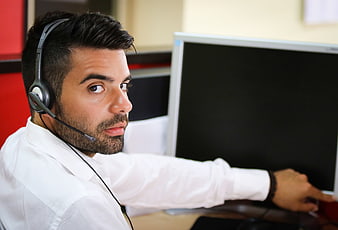 Male Call Center Agent with Headset Looking at Camera
