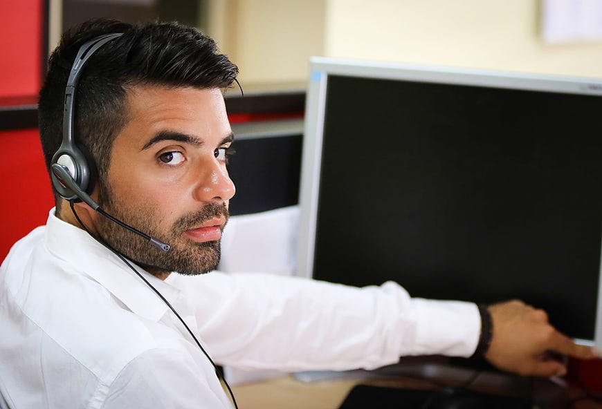 Male Call Center Agent with Headset Looking at Camera