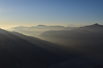 Misty Mountain Landscape with Sunbeams at Dawn