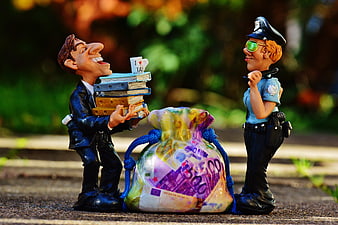 Tax Evasion Concept with Businessman and Police Figurines