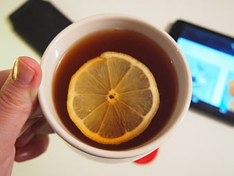 Top view of hot tea with lemon slice in white mug