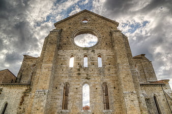 Medieval Abbey Ruins in Tuscany Under Dramatic Sky