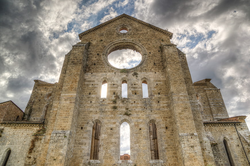 Medieval Abbey Ruins in Tuscany Under Dramatic Sky