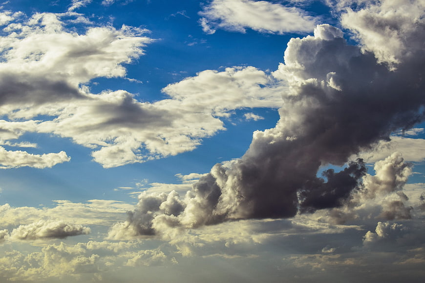 Dramatic Cumulus Clouds Against Blue Sky