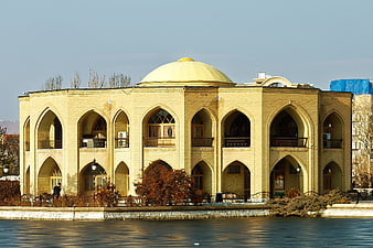Traditional Iranian Architecture with Golden Dome by Lake