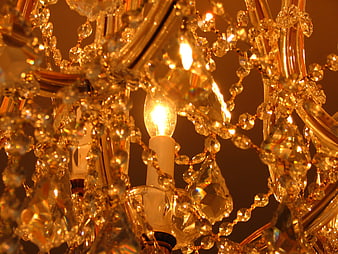 Close-up of glowing crystal chandelier with golden light