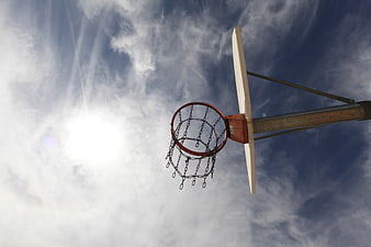 Low angle view of vintage basketball hoop against blue sky