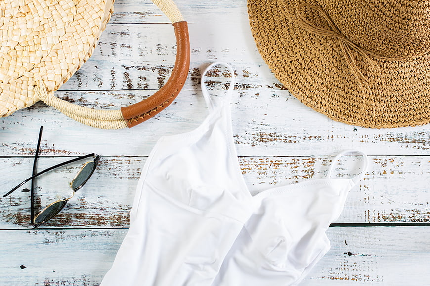 Summer Beach Essentials Flat Lay with White Swimsuit and Straw Hat