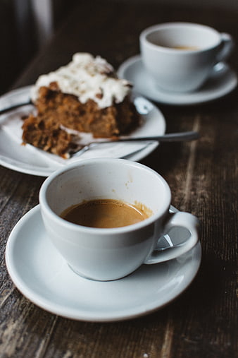 Espresso coffee and frosted cake on rustic wooden table