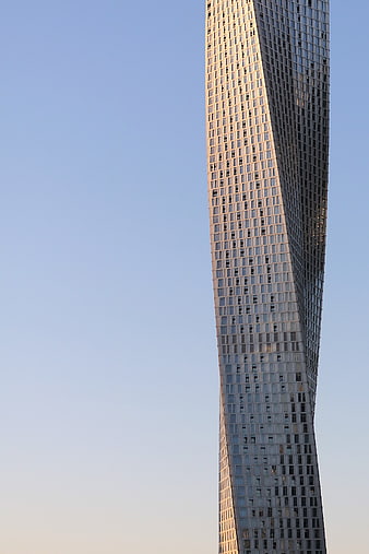 Twisted Skyscraper Architecture Against Blue Sky