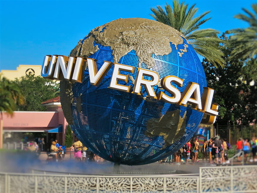 Universal Studios Globe Icon with Visitors and Palm Trees