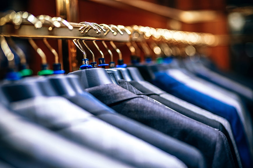 Close-up of suits on hangers in a clothing store