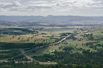 Aerial View of Rolling Green Hills and Winding Highway