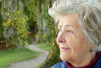 Senior Woman Portrait in Park with Peaceful Expression