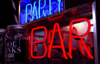 Red Neon Bar Sign and Cocktail Jars at Night