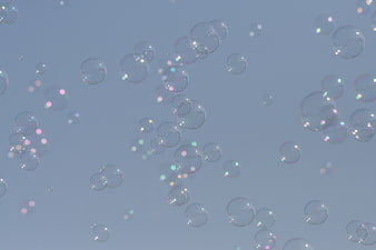 Abstract Soap Bubbles Floating Against Soft Blue Background