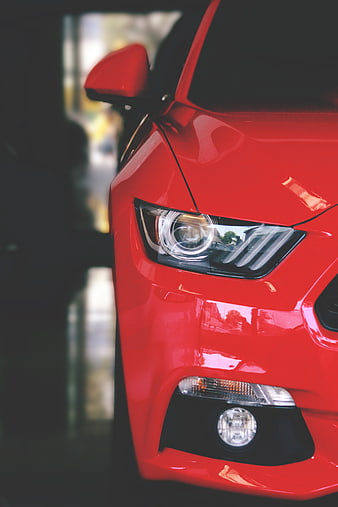 Close-up of Red Car Headlight and Front Bumper Detail