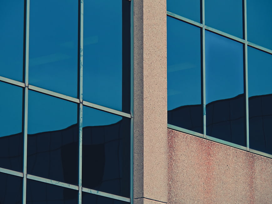 Modern office building facade with blue glass windows