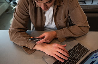 Man making online payment with credit card on laptop