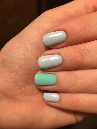 Close-up of hand with mint and grey manicure