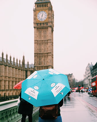 Person with Blue Umbrella Under Big Ben in Rain