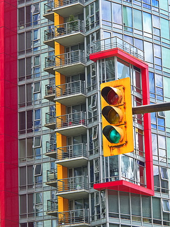 Urban Traffic Light Against Colorful Modern Apartment Building