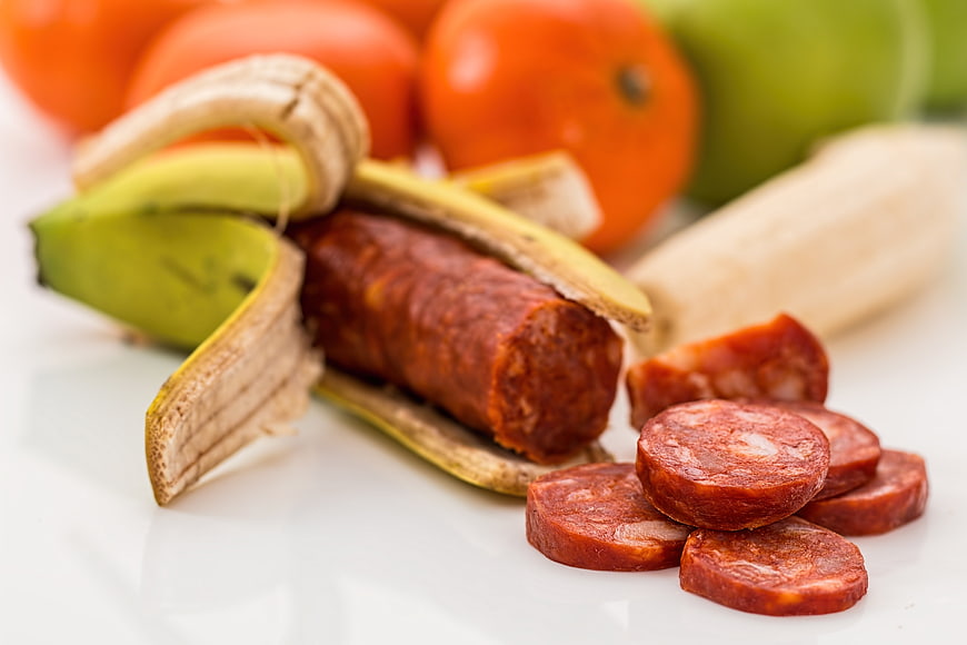 Chourico sausage inside a peeled banana with tomatoes