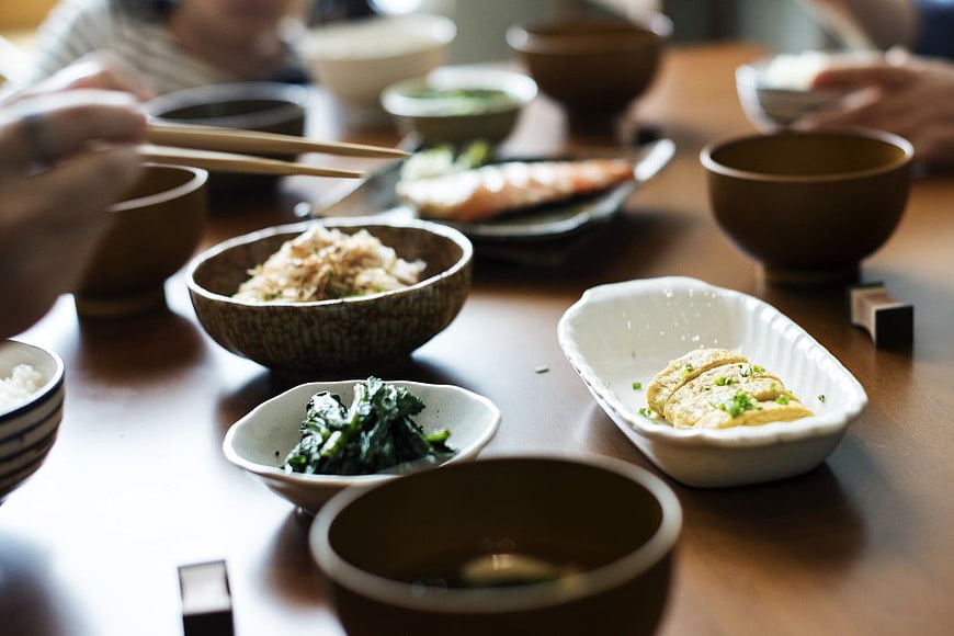 Traditional Japanese Meal with Chopsticks and Side Dishes