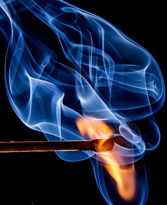 Burning Matchstick with Blue Smoke on Black Background