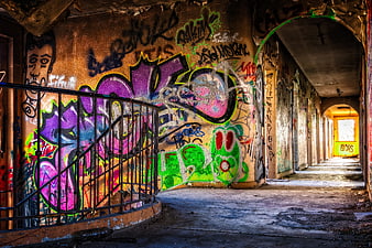 Abandoned Corridor With Vibrant Multicolored Graffiti Art