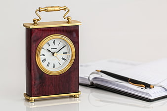 Vintage Carriage Clock on Desk with Notebook