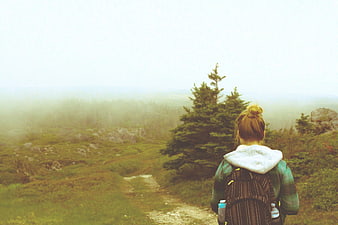 Woman Hiker Backpack Looking at Foggy Mountain Trail