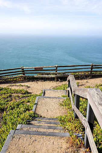Wooden stairs leading to scenic ocean cliff view