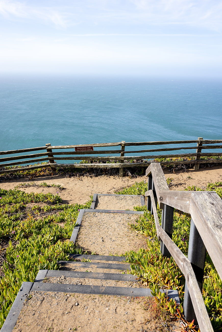 Wooden stairs leading to scenic ocean cliff view