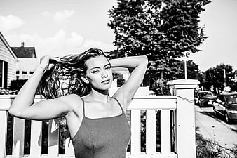 Black and white portrait of woman posing on porch