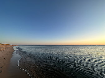 Serene Beach Landscape at Sunset with Calm Ocean Waves