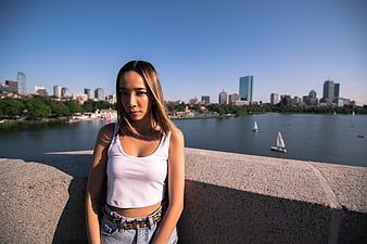 Young woman portrait with city skyline and river background