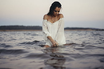 Woman in White Dress Standing in Ocean Water