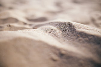 Close-up of textured gray sand ripples with shallow depth of field