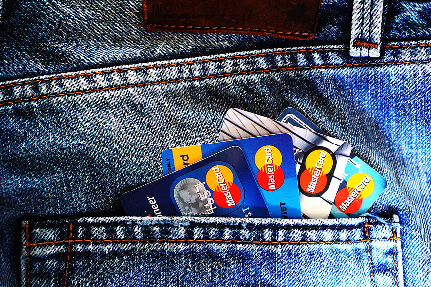 Mastercard credit cards in blue jeans pocket