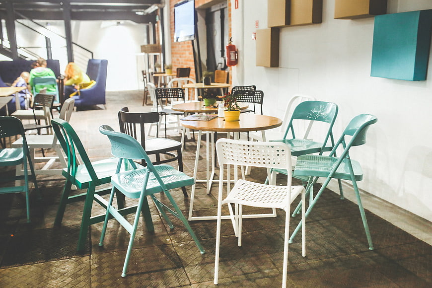 Modern cafe interior with teal and white chairs