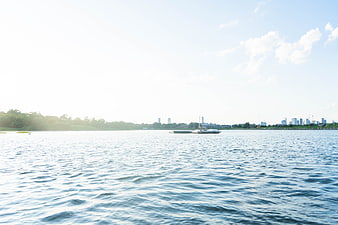 Serene River View with City Skyline and Floating Dock