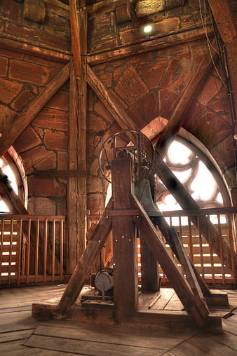Old church bell inside wooden tower structure