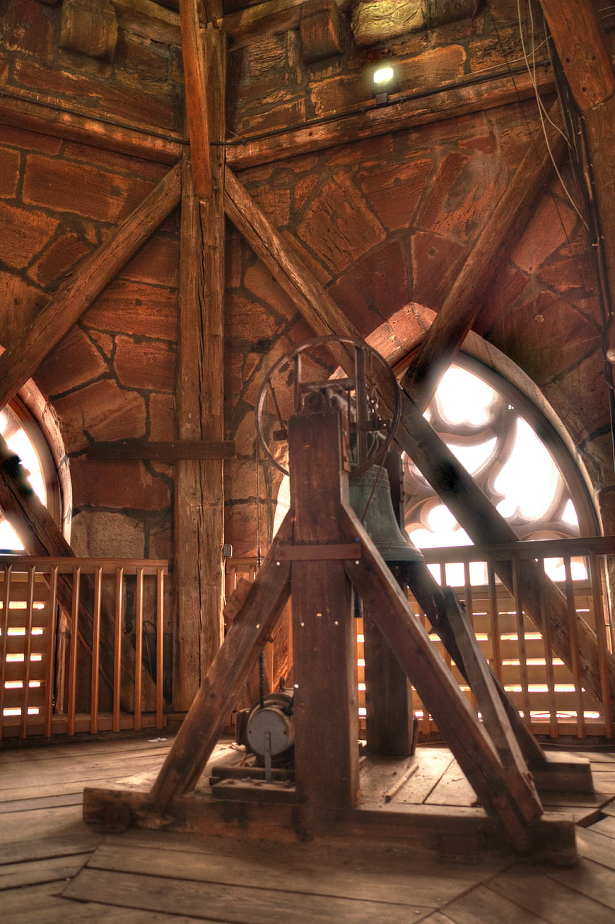 Old church bell inside wooden tower structure