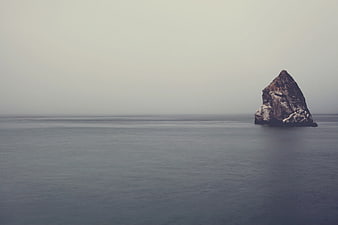 Minimalist Sea Stack Rock in Calm Ocean