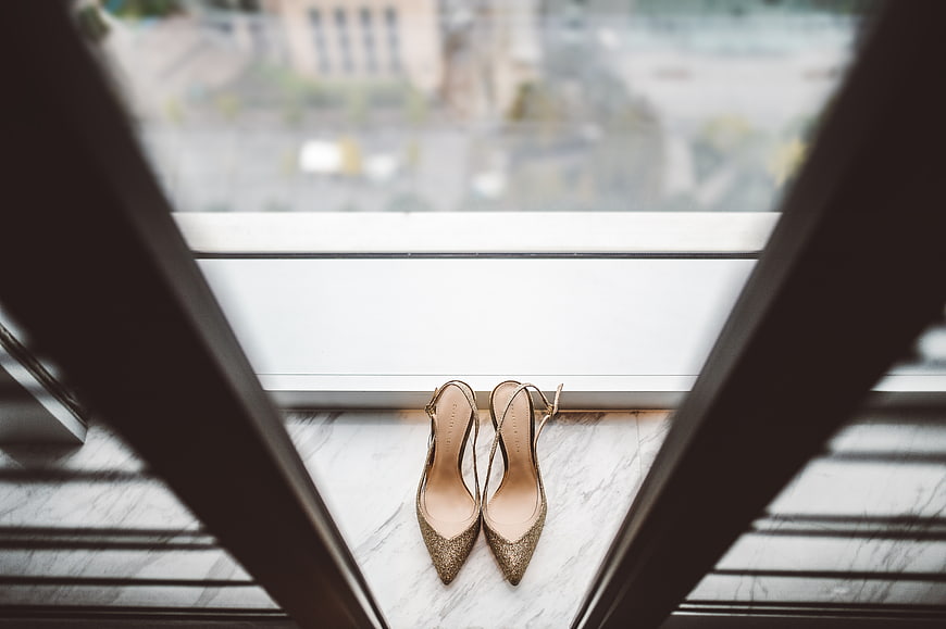 Gold glitter high heels on marble windowsill