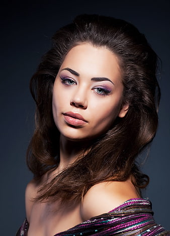 Portrait of a woman with purple eyeshadow and wavy hair
